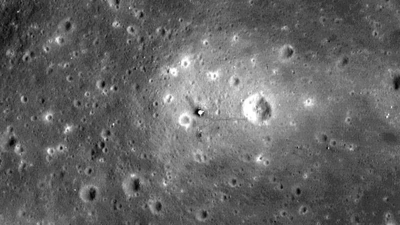 Apollo 11. LROC NAC M111443315R, 29 October 2009. The bright spot is the descent stage. The line running away from it is the footpath to the crater.