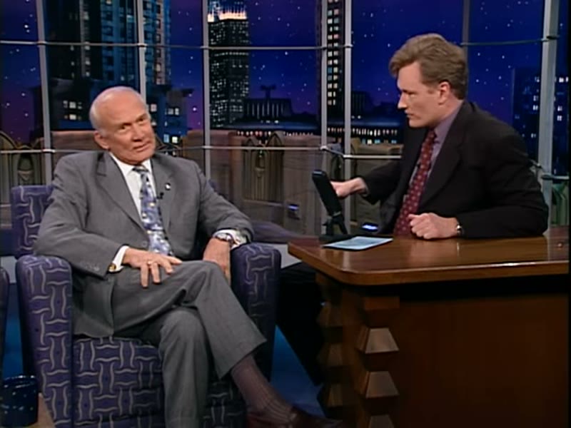 Aldrin on Late Night with Conan O'Brien, 17 May 2000, during the landing-broadcast exchange. Frame from the Team Coco upload.