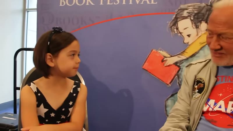 Zoey and Aldrin, National Book Festival, 5 September 2015. Her question was why nobody had been back in so long. Frame from the Roarbots upload, about 7:24.