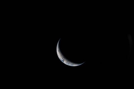 Crescent Earth. Sliver of Earth through an Orion window, flight day 3—shows illuminated limb geometry expected from cislunar vantage. NASA/JSC. NASA image page